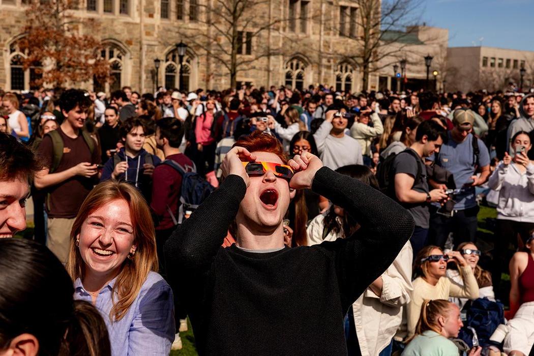 A group of students watching the solar eclipse
